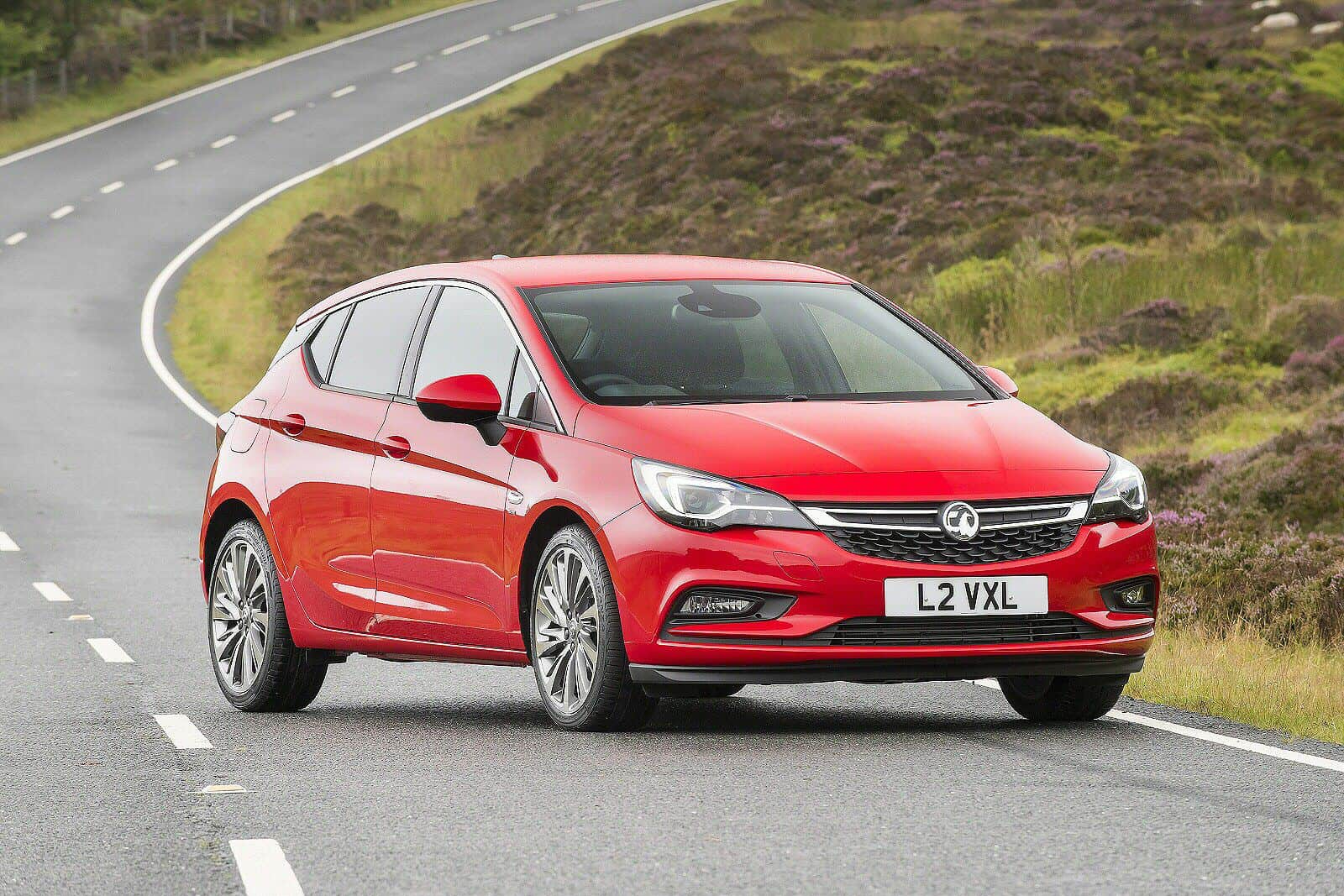 vauxhall astra in red driving along country roads