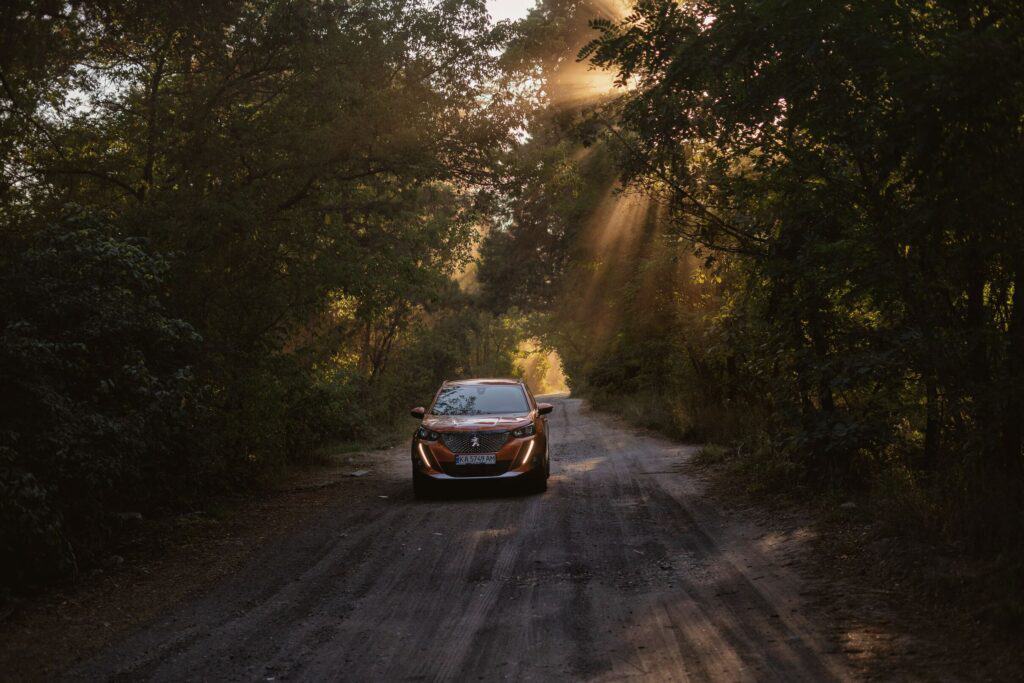 A white Peugeot 5008 SUV parked in a scenic countryside setting.