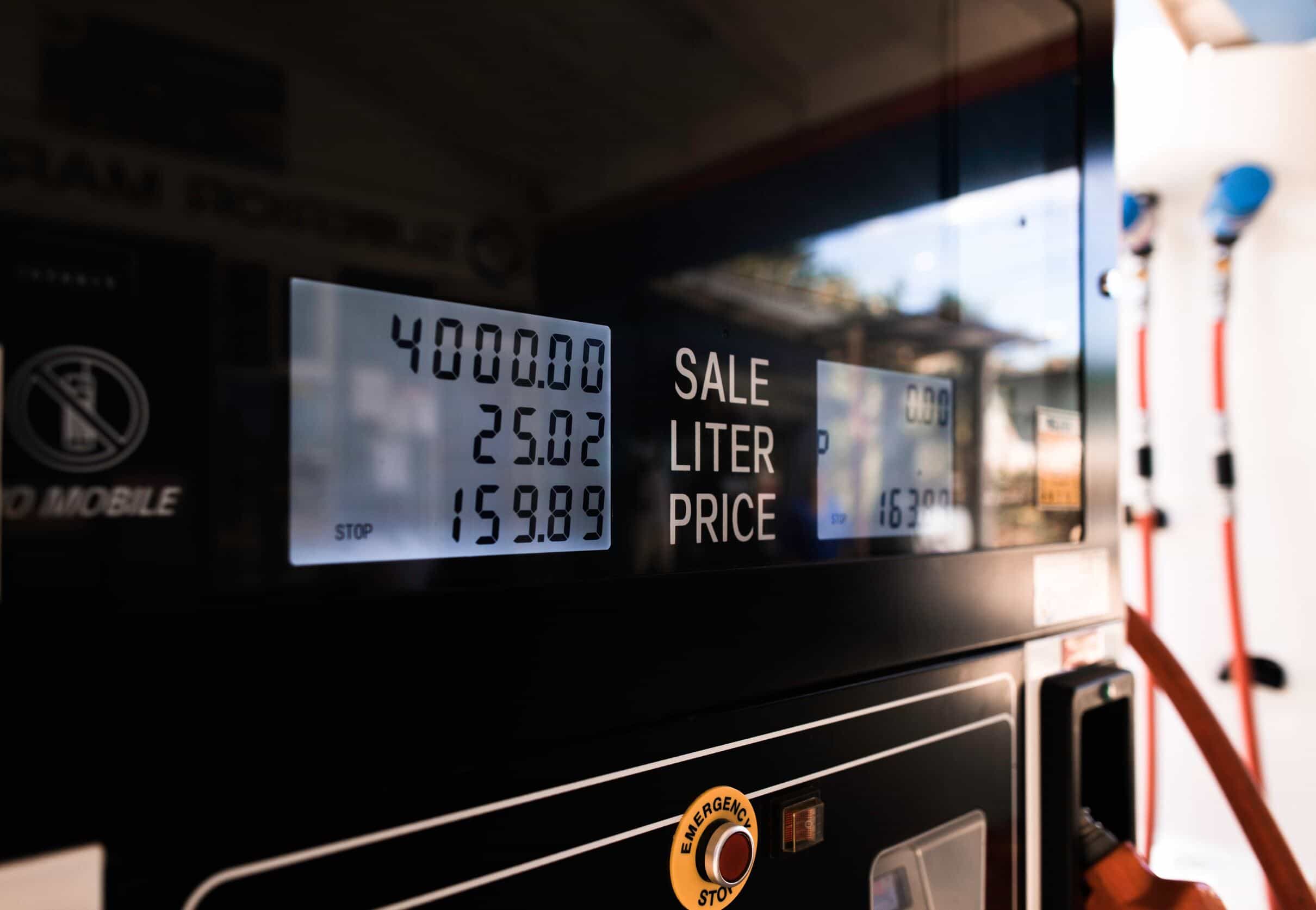 A fuel station with fuel dispensers and vehicles refueling.