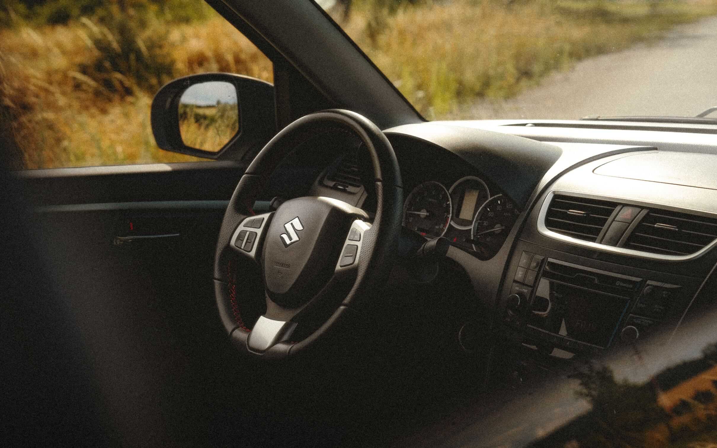The interior of a Suzuki Swift, showcasing modern design and comfort features.

