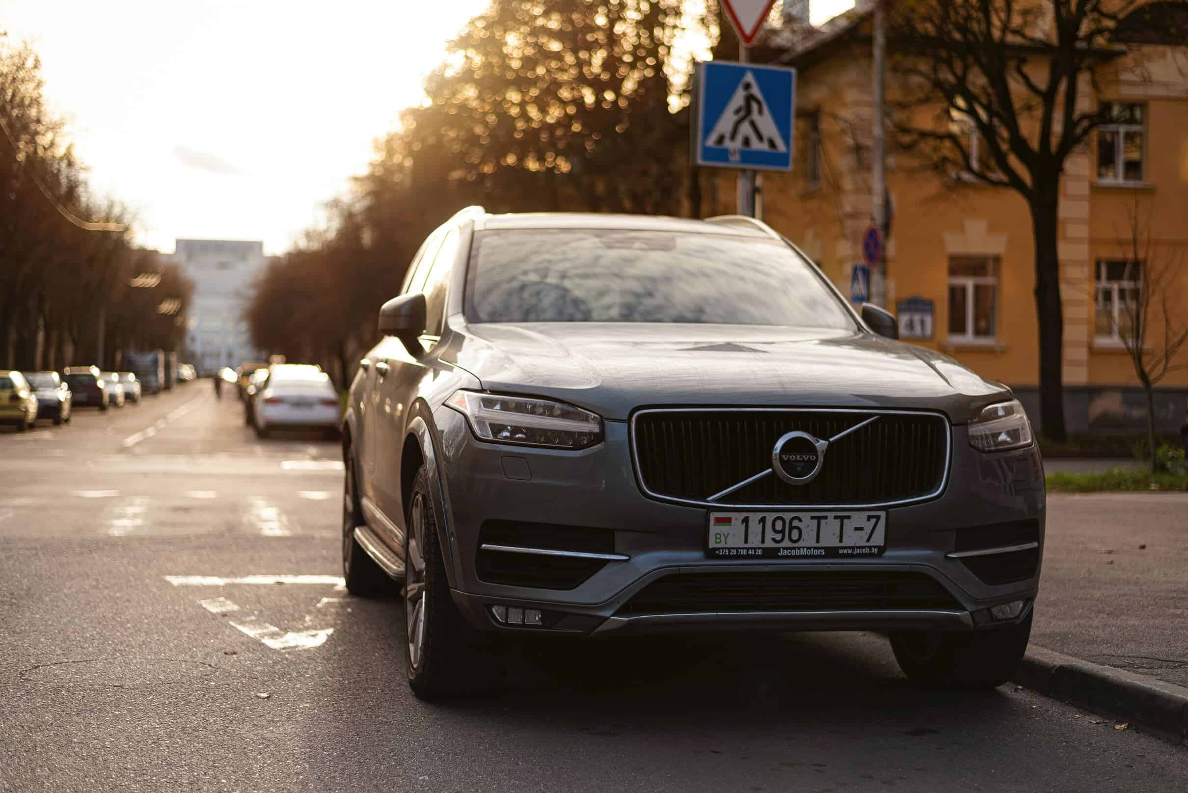 A silver Volvo XC90 SUV parked in an urban environment.