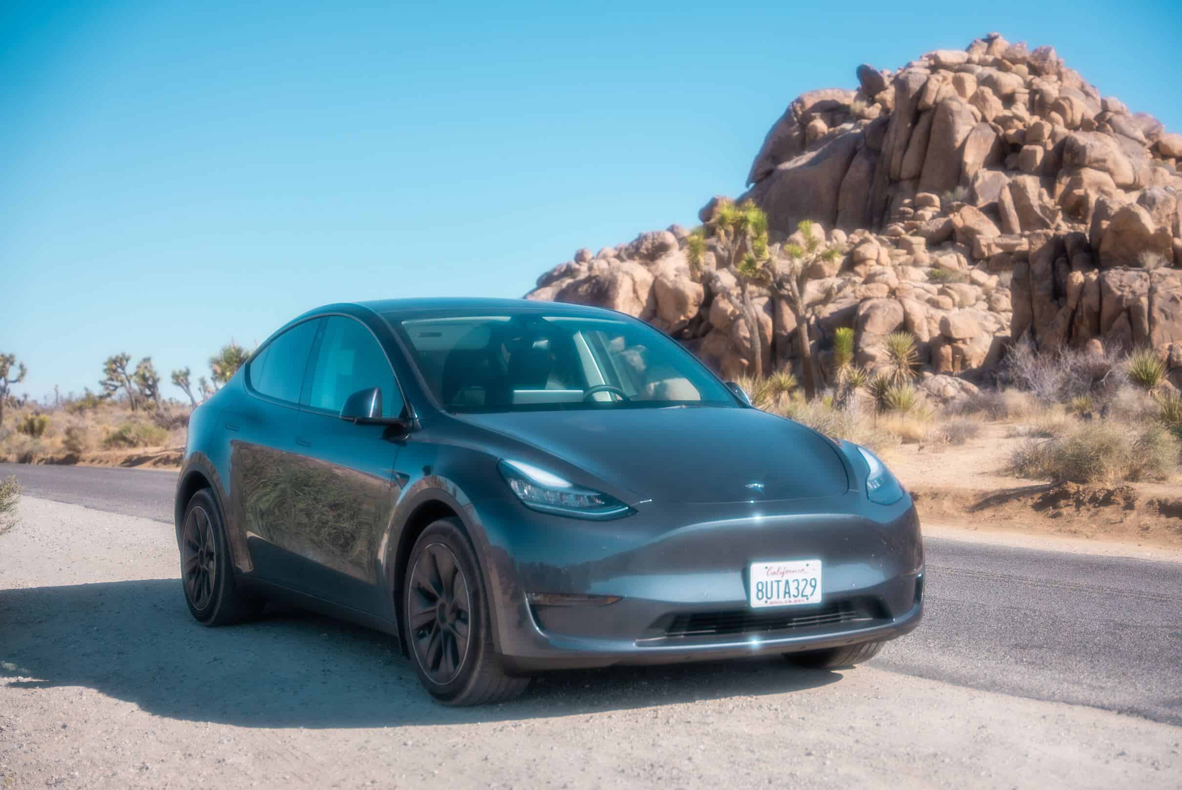 Tesla Model Y: A red Tesla Model Y parked in a scenic outdoor location, highlighting its eco-friendly design and family-friendly features.