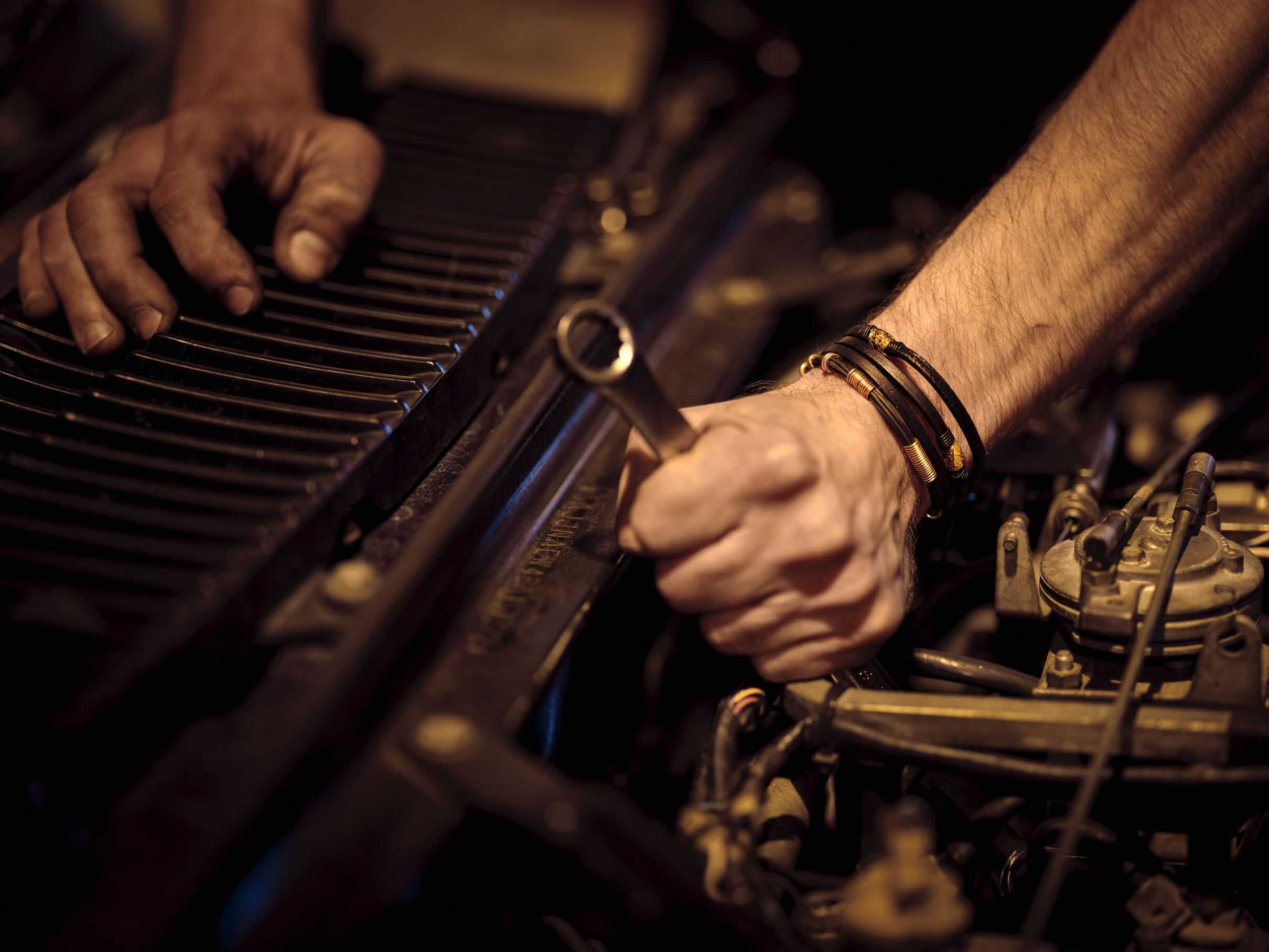 Professional vehicle mechanic working under the hood of a car