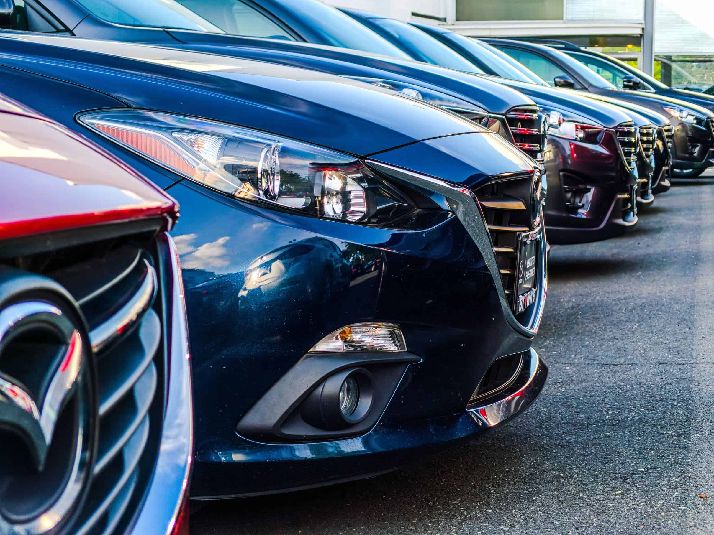 Image of a line-up of used cars at a dealership