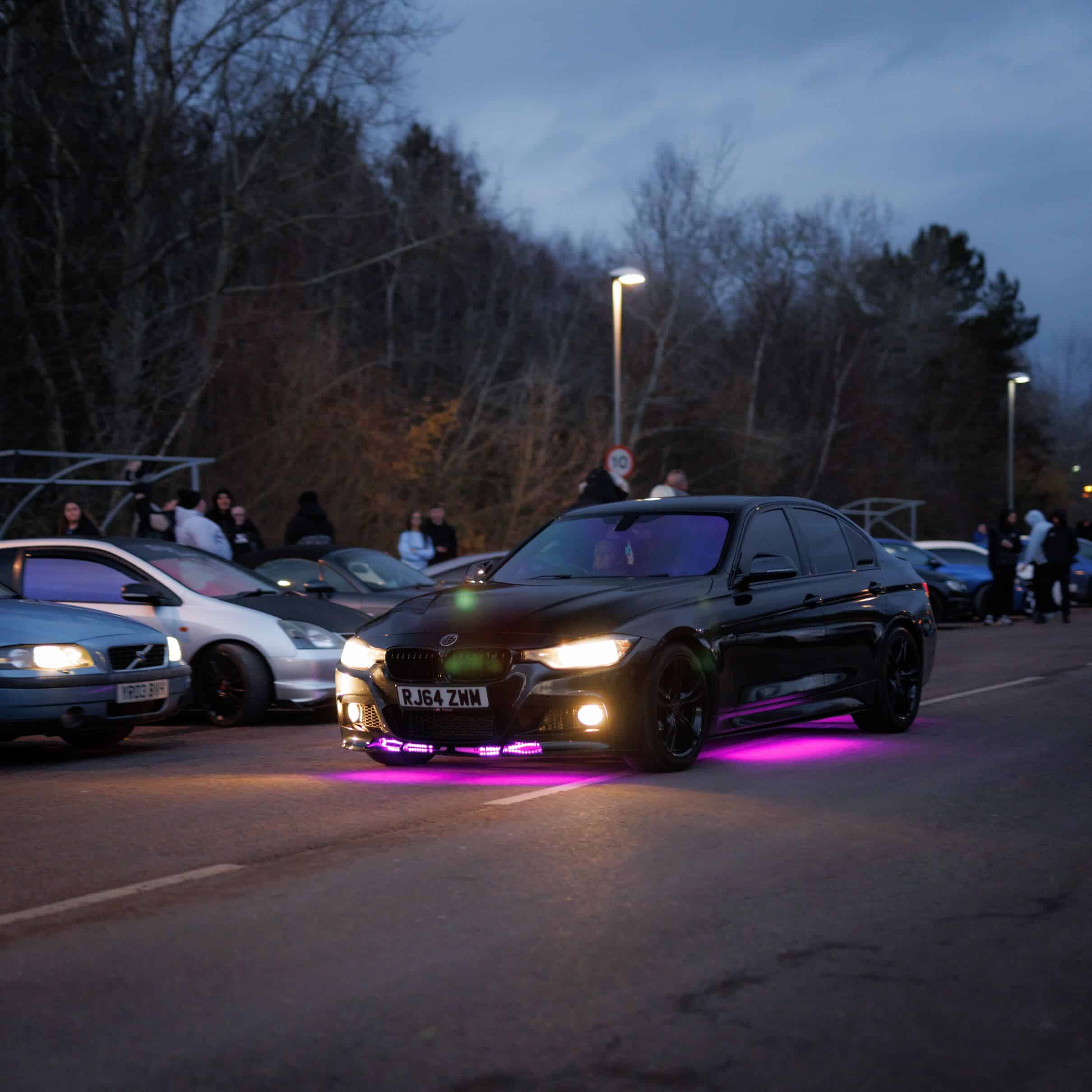 Diverse array of cars at a UK car meet showcasing automotive enthusiasm