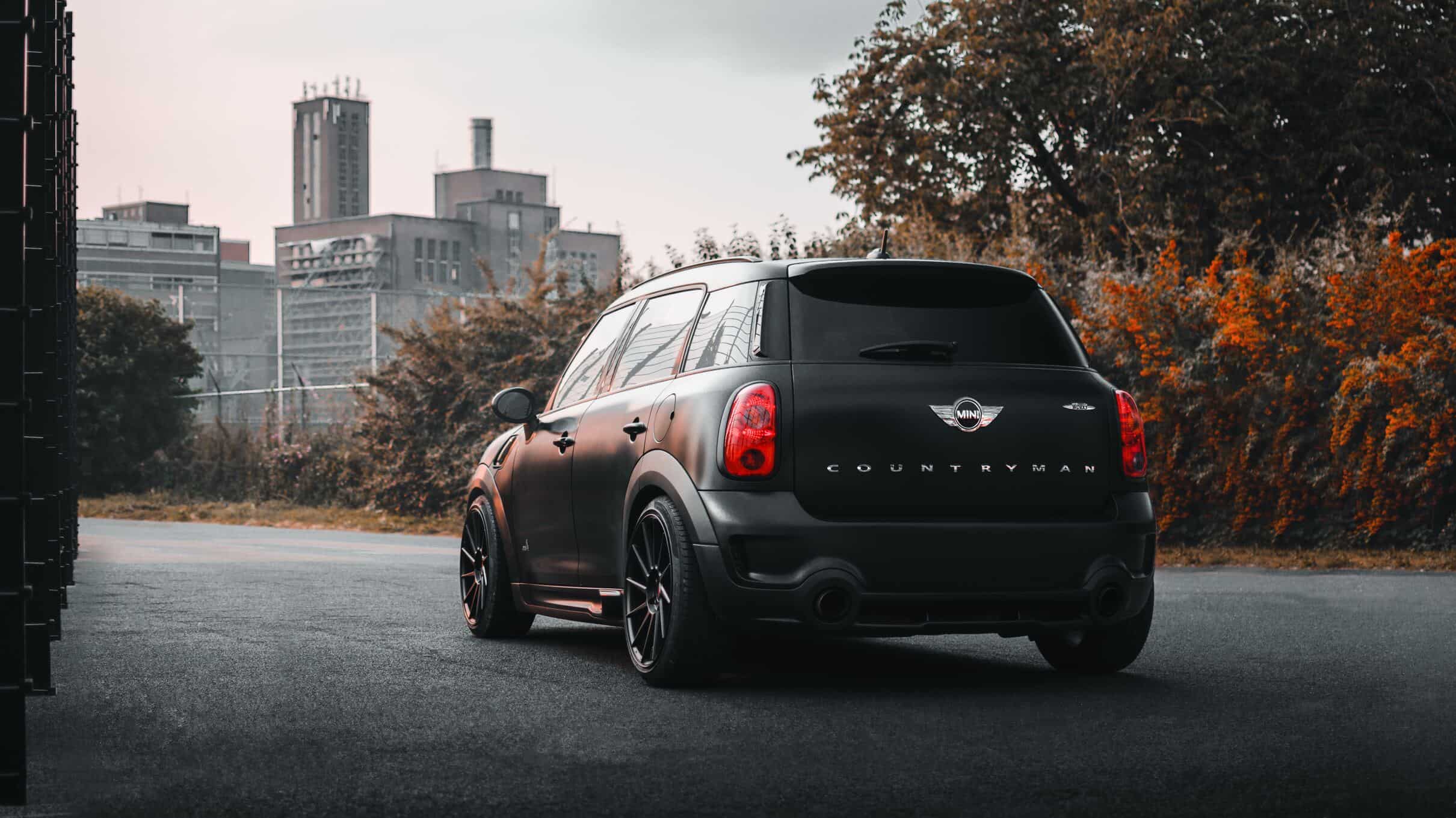 Red Mini Cooper Countryman driving through snow-covered road